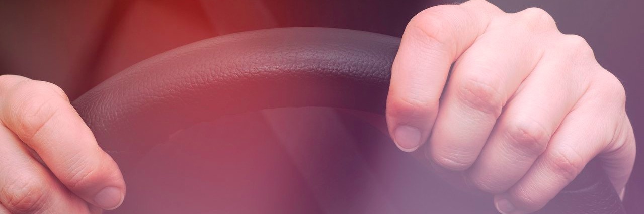 Stranger Asked If I Was All Right After He Saw Me Crying in My Car woman holds on to the steering wheel of a car