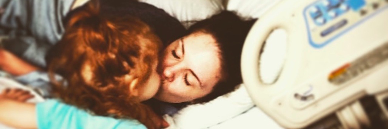 How My Daughter Said She Would Help Get Me a New Intestine woman lying in hospital bed kissing her toddler daughter