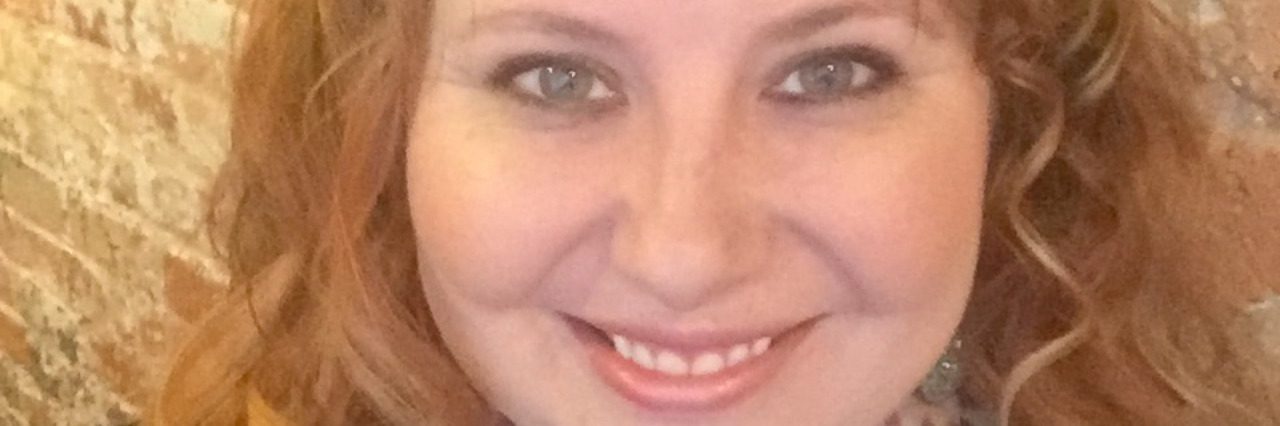 What You Can’t See About My Borderline Personality Disorder in a Photo Woman smiling in front of camera in closeup
