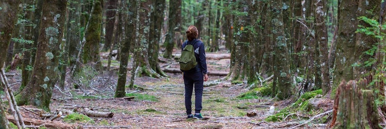 Woman With Autism Spectrum Disorder Describes How She Sees the World young woman looking at trees in forest
