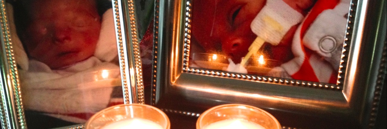 How I Found Support and Community After Child Loss Two framed photos of babies with lit candles in front of each