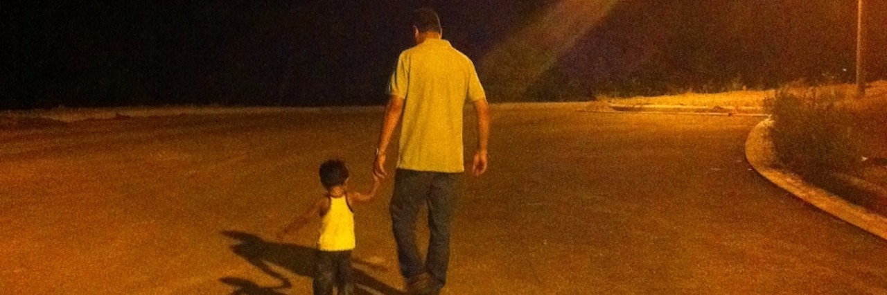 Mom Thanks Lady at Grocery Store for Kindness During Son's Meltdown dad and son walking hand in hand