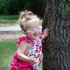 Ashlyn near a tree outside smiling.