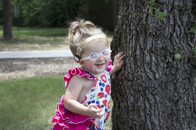 Ashlyn near a tree outside smiling.