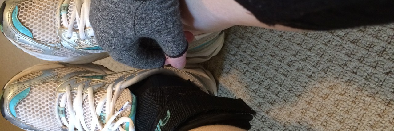 When 'Positive' Body Image Messages Hurt People With Disabilities Alana tying her sneakers.