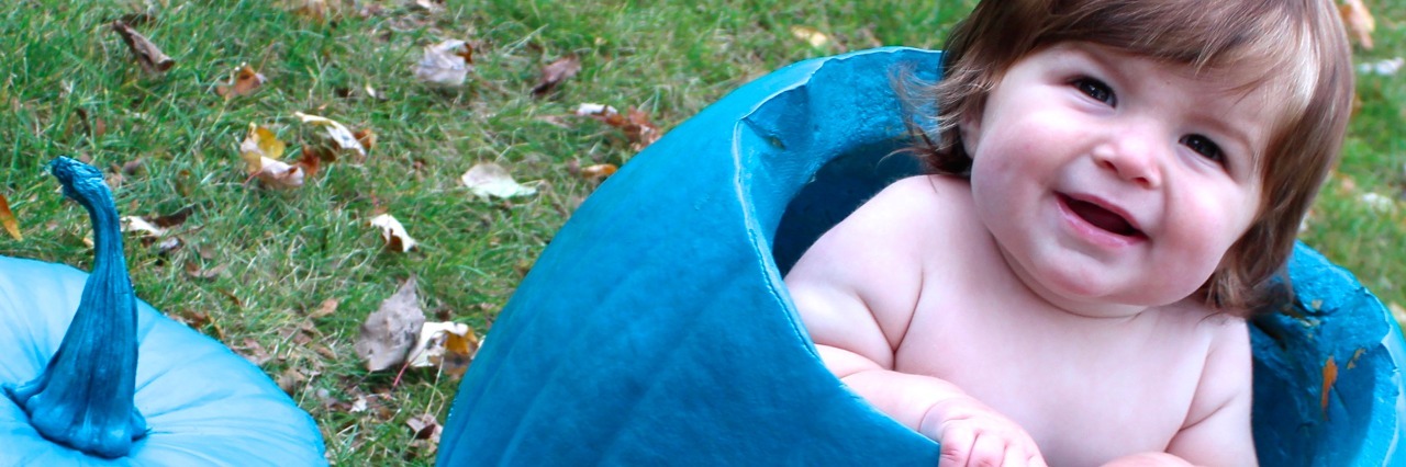 Parenting a Child With Food Protein-Induced Enterocolitis Kristine's child inside a teal pumpkin