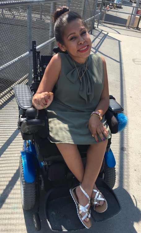 Precious smiling in her wheelchair.