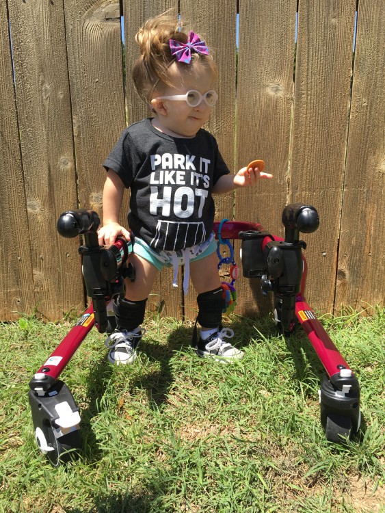 Ashlyn with her walker outside.