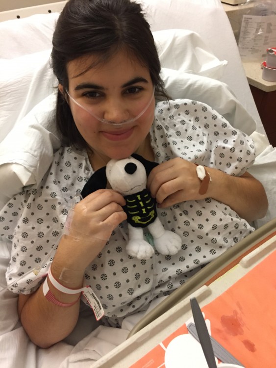 In the hospital post-surgery, oxygen and all, with my new skeleton Snoopy from my best friend.