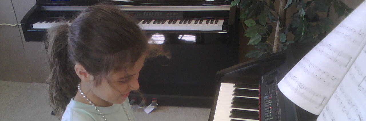 Young girl playing the piano