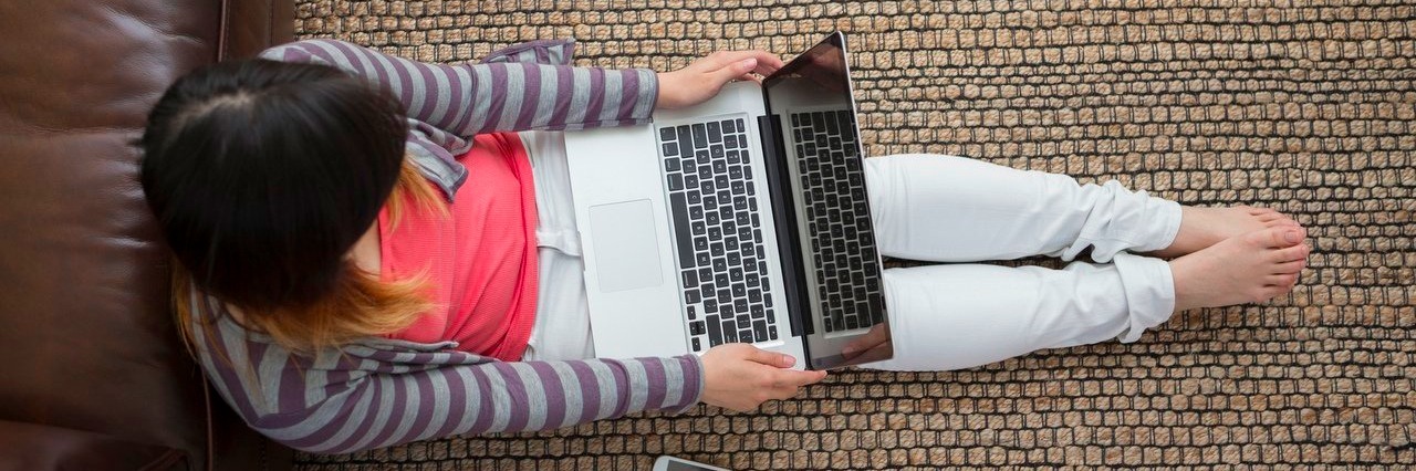woman sitting on floor with laptop