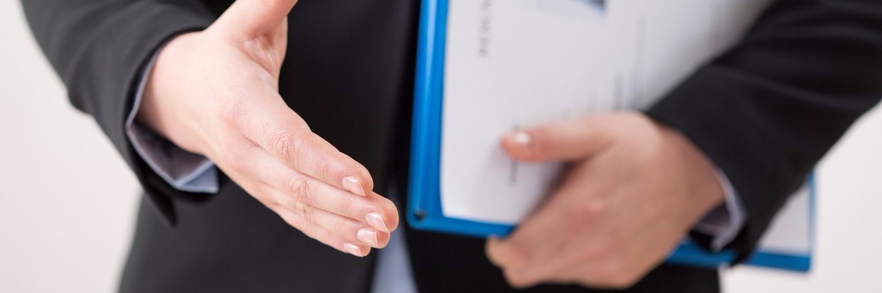 Letter to Employers Interviewing Job Candidates With Autism woman meets for a job interview with resume under her arm