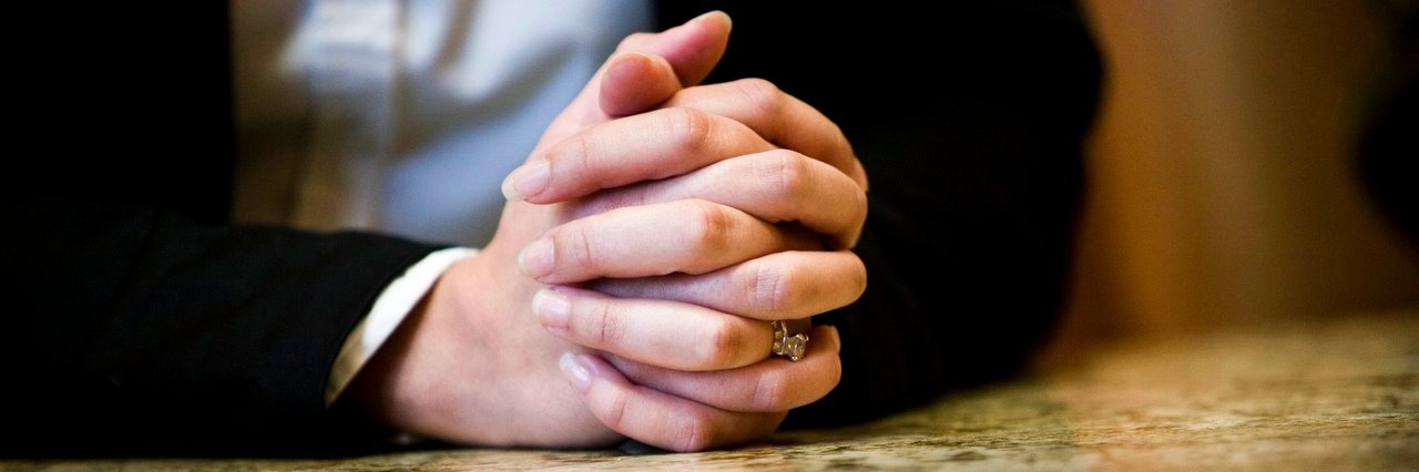 Letter to Parents About to Enter Their Child’s IEP Meeting woman with hands on conference room table