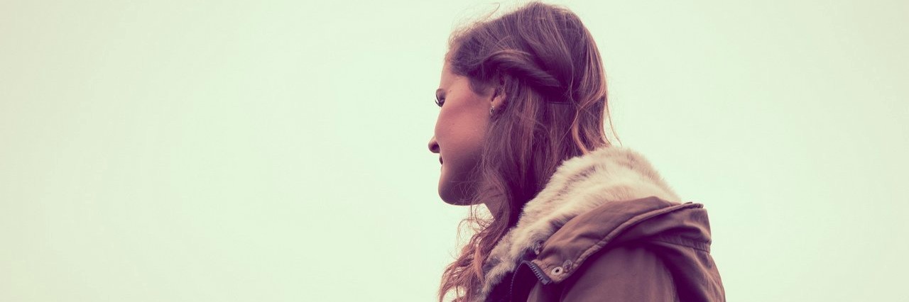 Woman Explains Why She’s Hesitant to Discuss Her ADHD Diagnosis young woman staring into the distance