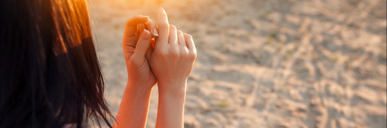 Steps I Took to Help Cope With My Grief woman sitting at the beach