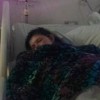 young woman lying in hospital bed
