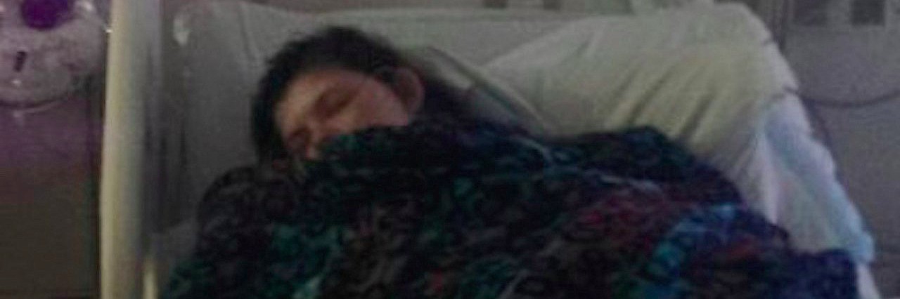 Crohn’s Disease: Waiting for My ‘Can’ts’ to Become ‘Cans’ Again young woman lying in hospital bed