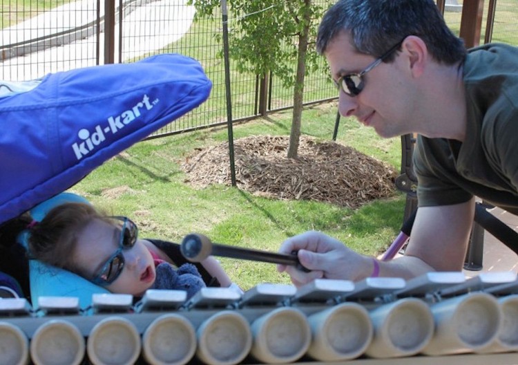 man plays xylophone for his daughter