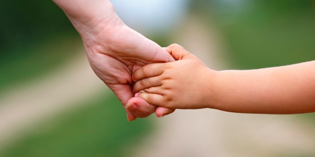 mother holding child’s hand