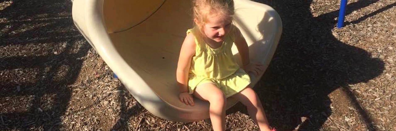 What This Photo Doesn’t Tell You About Sensory Processing Disorder girl playing in the park