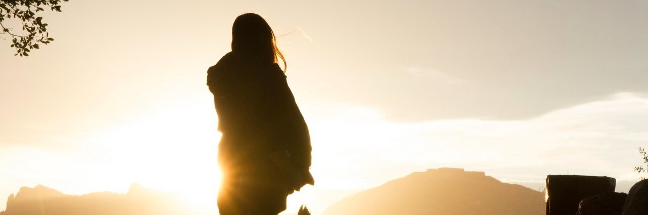 Woman With Reactive Hypoglycemia Explains What It Means to Her woman staring at the sunset