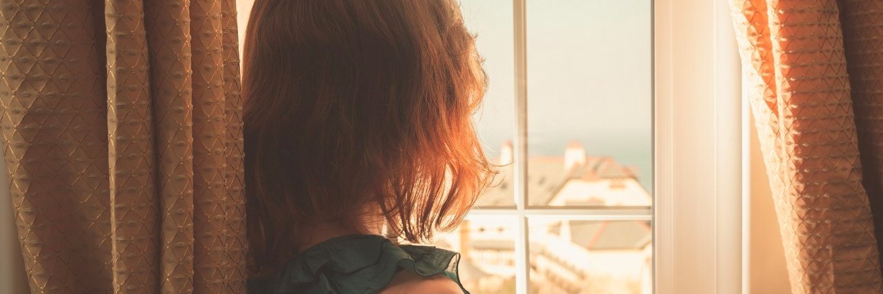 Things to Know Once You’re Diagnosed With Chronic Pain young woman looking out a window