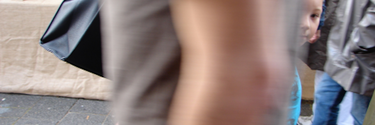 blurry arm with child peaking through