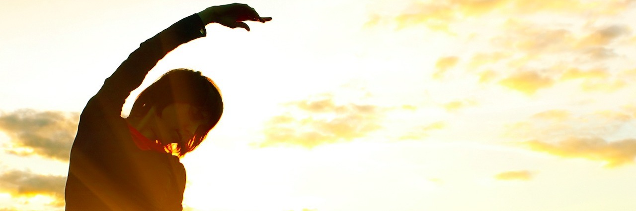 How to Handle Fear in OCD and Depression woman in a field of flowers at sunrise