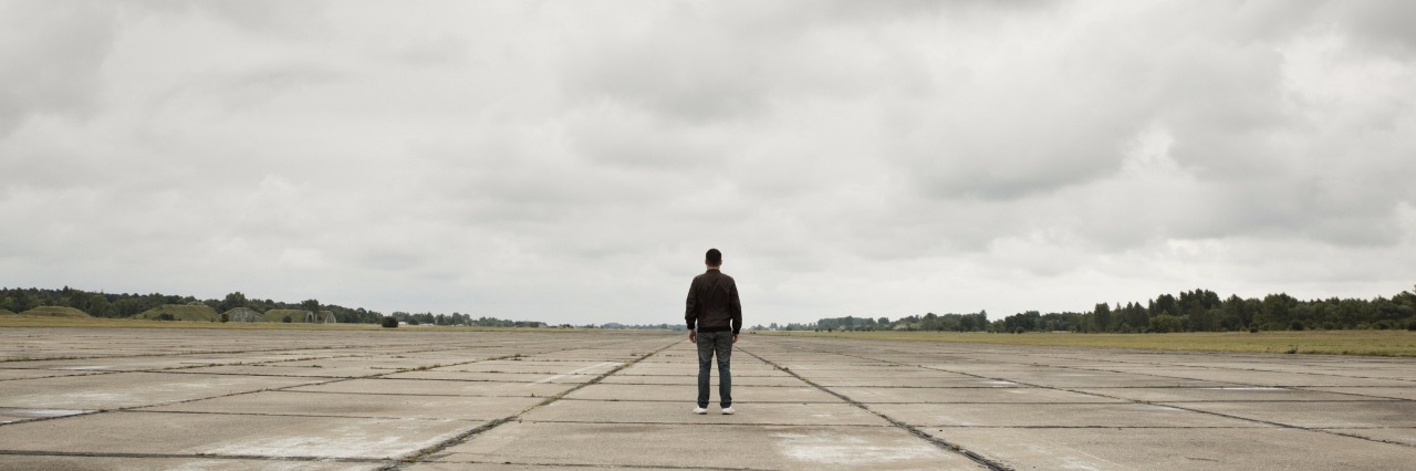 Depression: When Men Can't Ask for Help man standing along in the middle of a runway