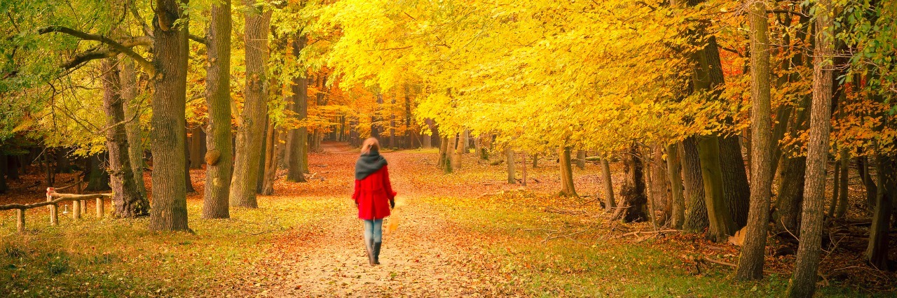 Bipolar Disorder: Coping With Changing Seasons woman walking in a park in autumn
