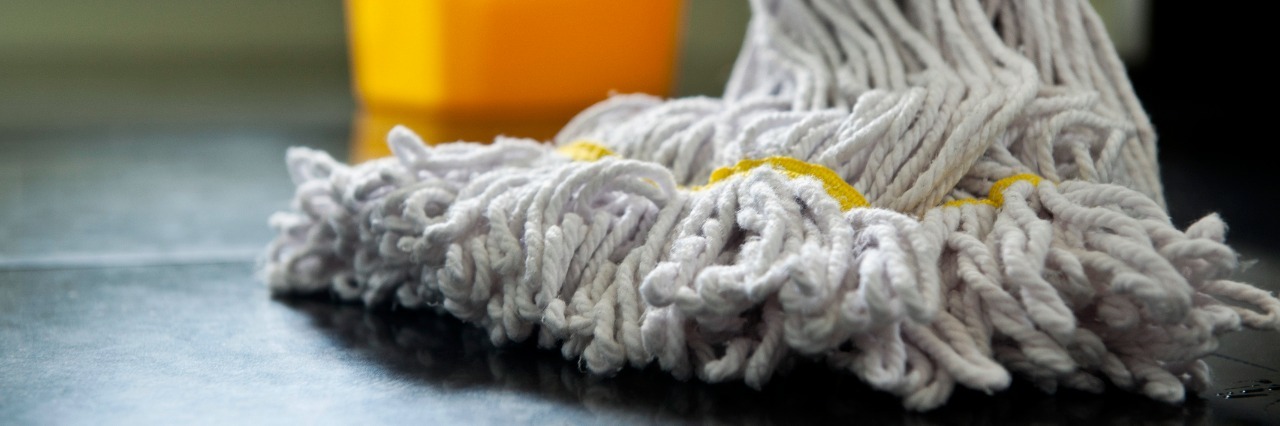 In Defense of Vocational Programs for Students With Disabilities close up photograph of a mop and bucket with shallow depth of field