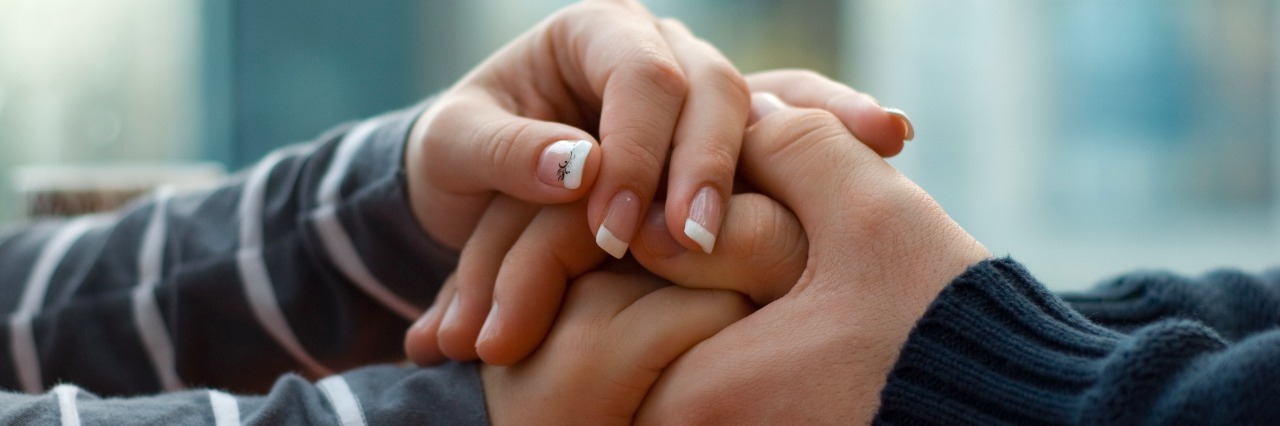 Man and woman holding each other hands.