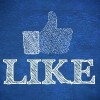 thumbs up representing social network logo above the word like written on blue background