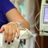 Infusion pump feeding IV drip into patients arm focus on needle
