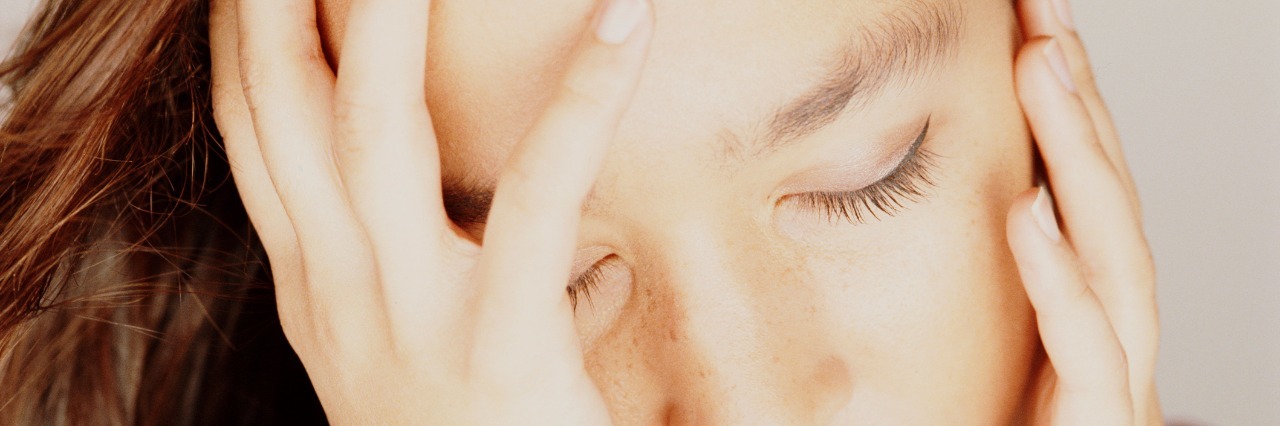 Depression: A Deadly Disorder close up of young woman with eyes closed head in hands