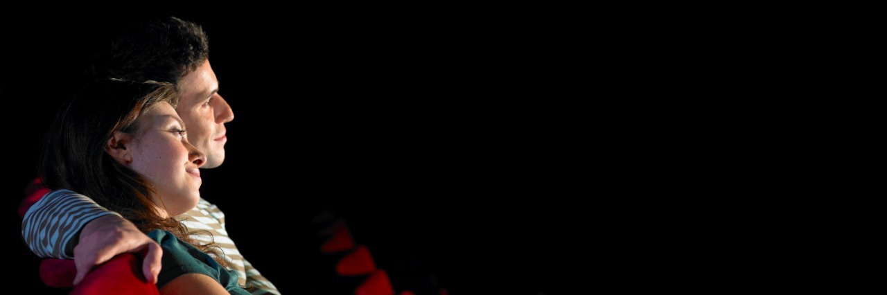Advice for Dating With a Mental Illness side view of a couple in a dark movie theater