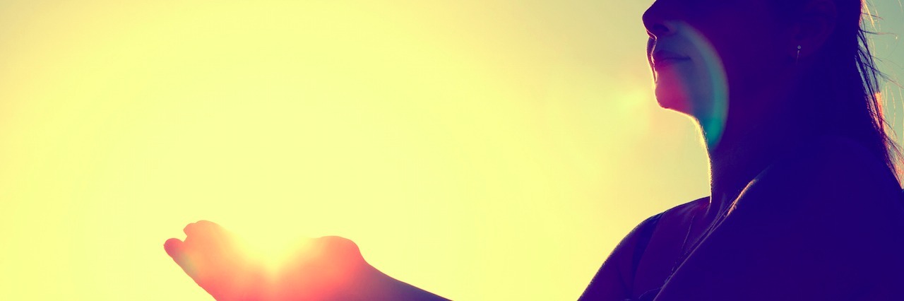 Letting Go of the People Who Don't Accept Your Mental Illness woman in front of a sunset