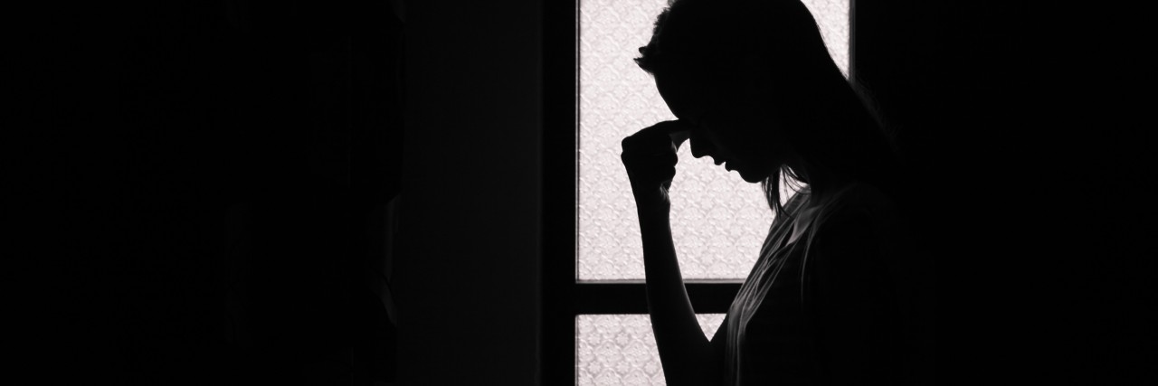 Letter to Read to Myself If I'm Thinking About Killing Myself Depressed young woman in a dark room