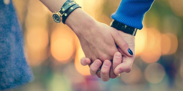 How We've Made Our Marriage Work as Special Needs Parents Couple holding hands outdoors.