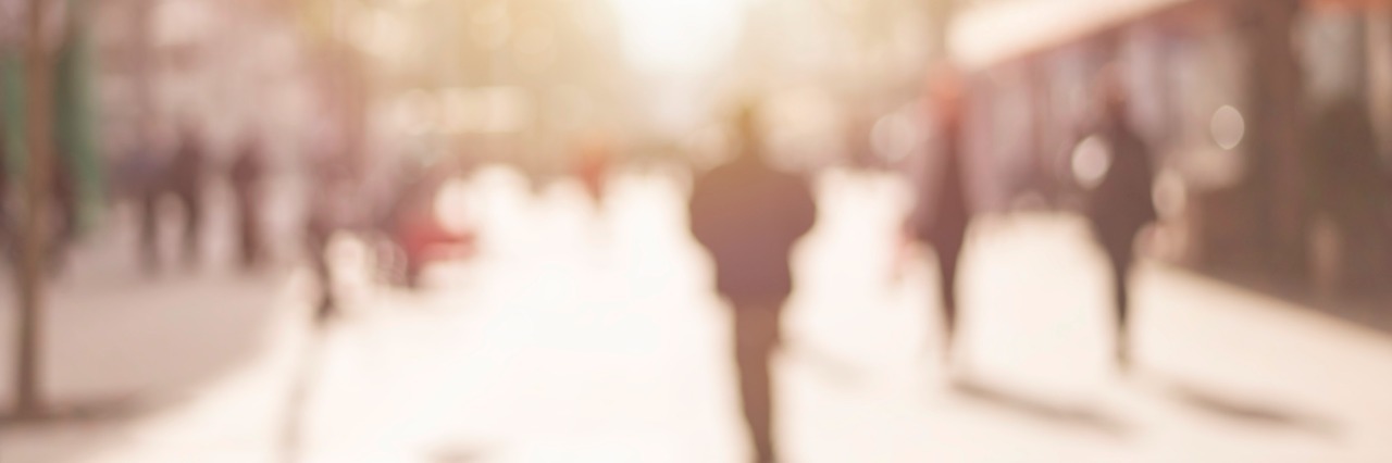 What to Know for Invisible Illness Awareness Week City commuters. Abstract blurred image of a city street scene.