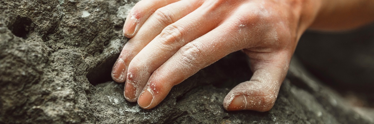 When You Are Struggling to Hold on in Depression a hand holding into a rock