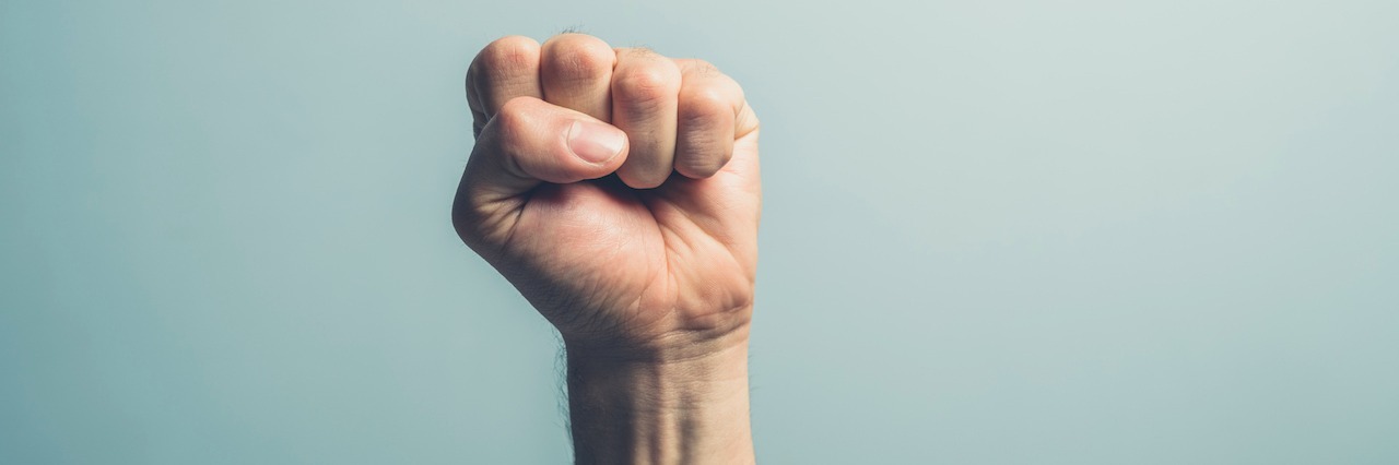 Dignity for People With Mental Illness Who Encounter the Police man holding first in the air