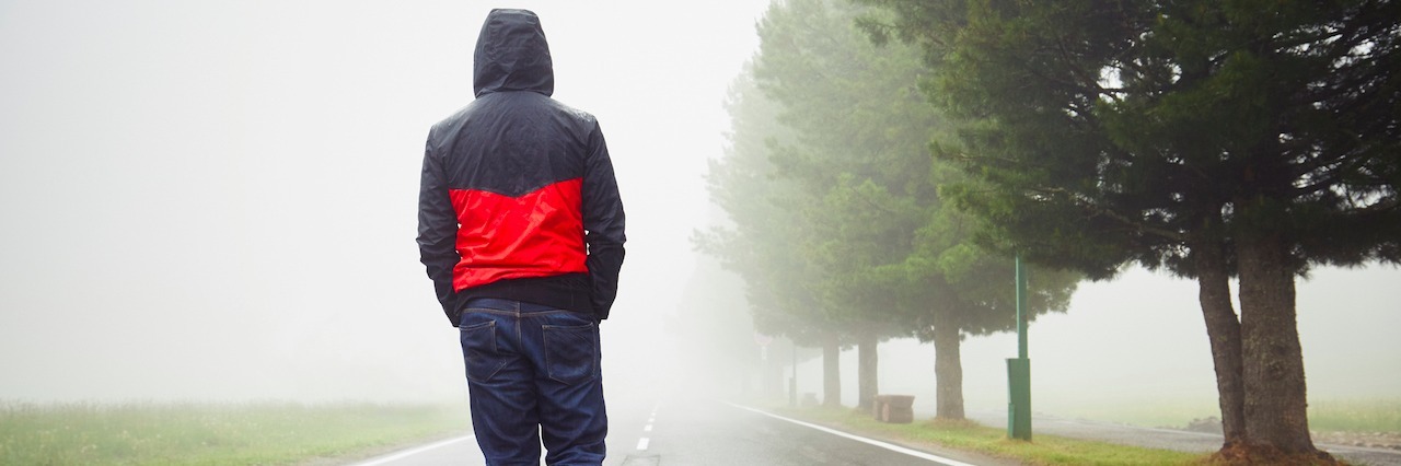 How Men Ruminate While They're Depressed, and Tips to Help man walking in the rain