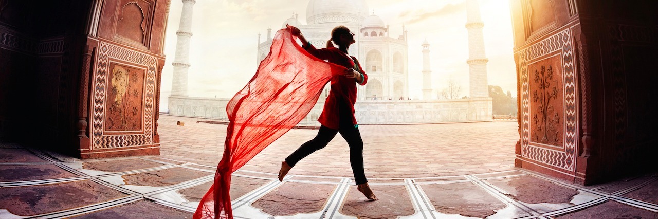 woman dancing in front of the Taj Mahal