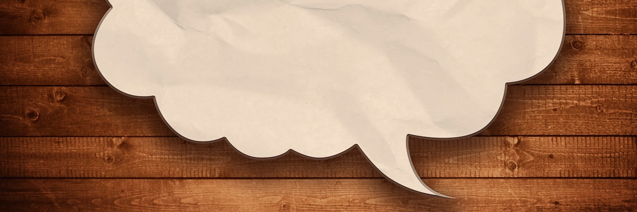 Trying to Ignore the 'Anorexic Voice' During Eating Disorder Recovery speech bubble on wood background