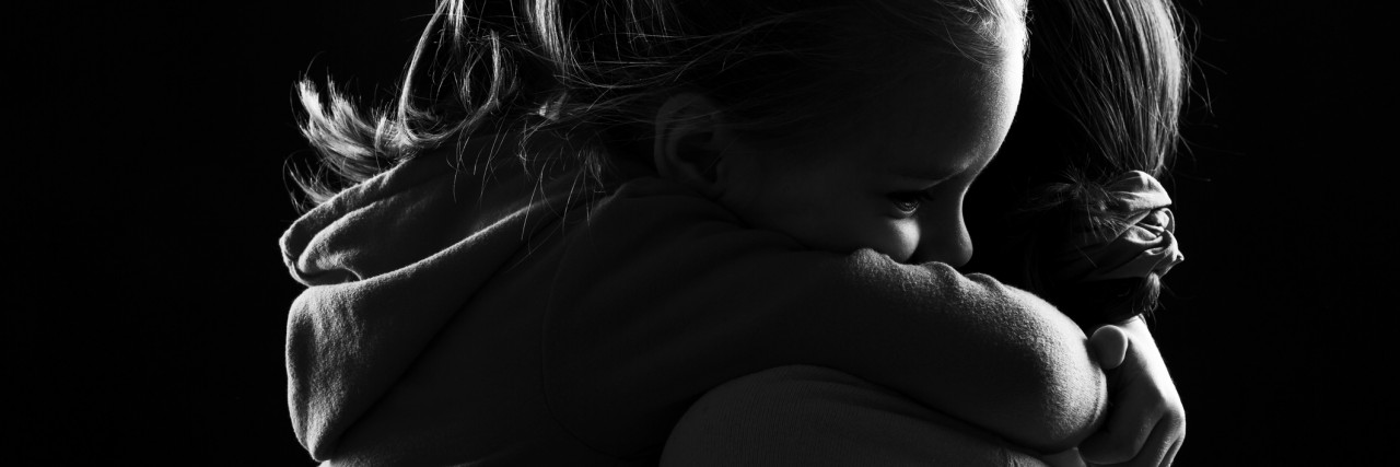 What Every Suicide Loss Survivor Should Know Black and white image of a little girl hugging her mother