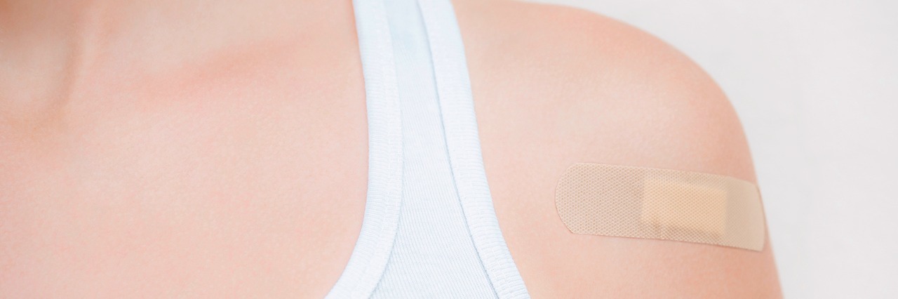 woman with a bandaid on her shoulder