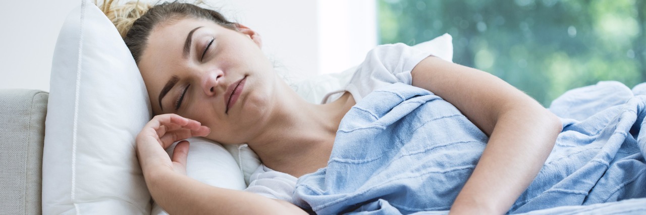 What It Feels Like to Have a Cold and Fibromyalgia Feverish woman lying under blanket with thermometer
