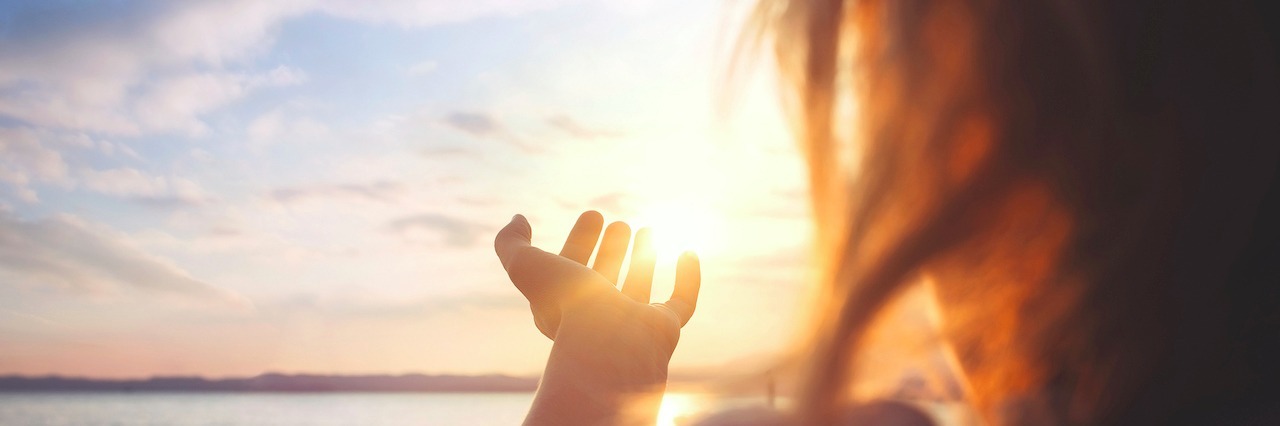 Remaining Hopeful on Hard Days woman at the beach watching the sunset