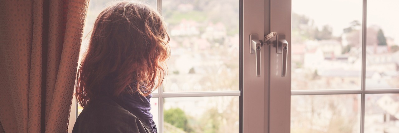 Pain Shouldn't Be a Competition Young woman is looking out the window